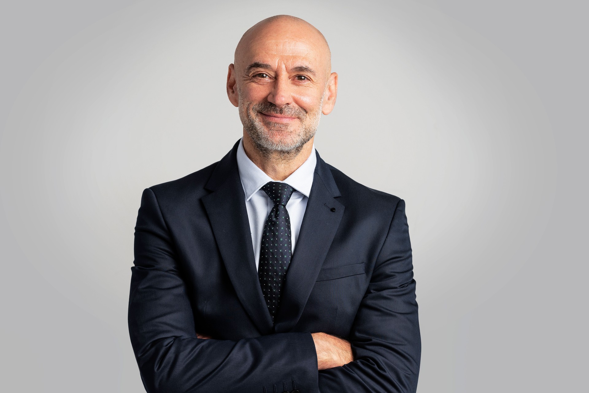 Portrait of senior businessman smiling at isolated background