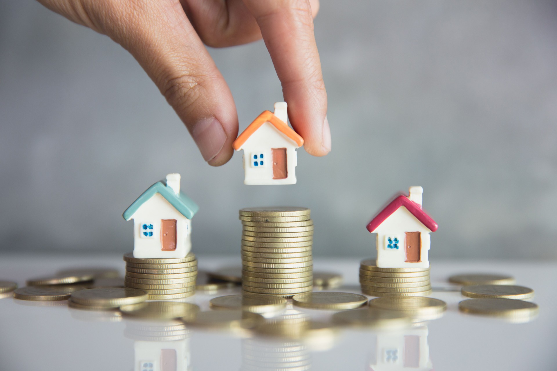 House and coins on table. Property investment and house mortgage financial concept,